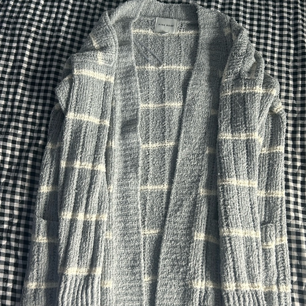 A grayish blue sweater with crème colored stripes